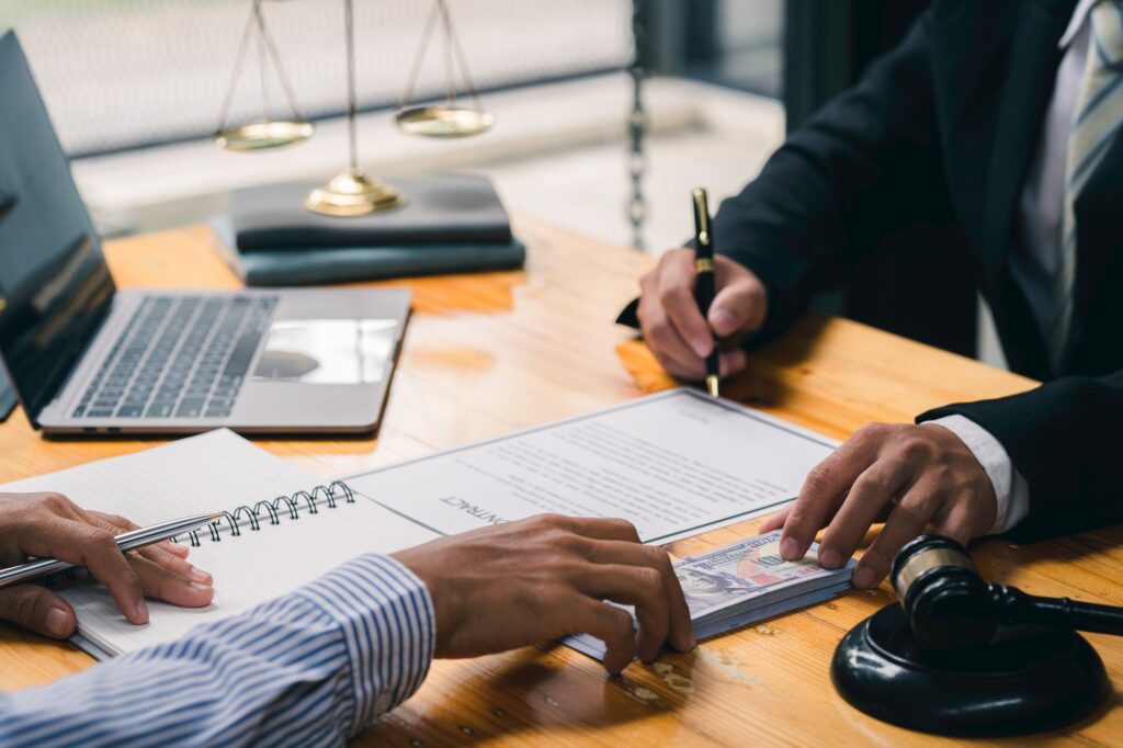 Businessmen are holding cash envelopes in order to bribe lawyers the investment project participant
